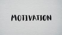 Inspirational word 'Motivation' in black on a white textured canvas background.