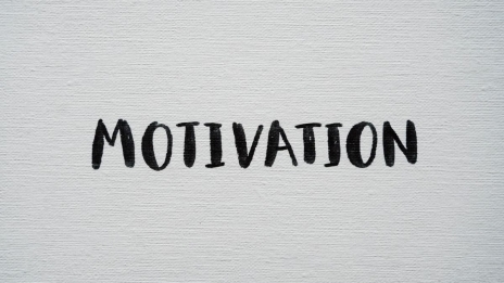 Inspirational word 'Motivation' in black on a white textured canvas background.